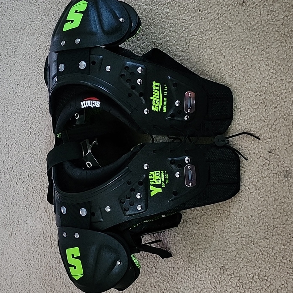 Football shoulder pads, color black and green